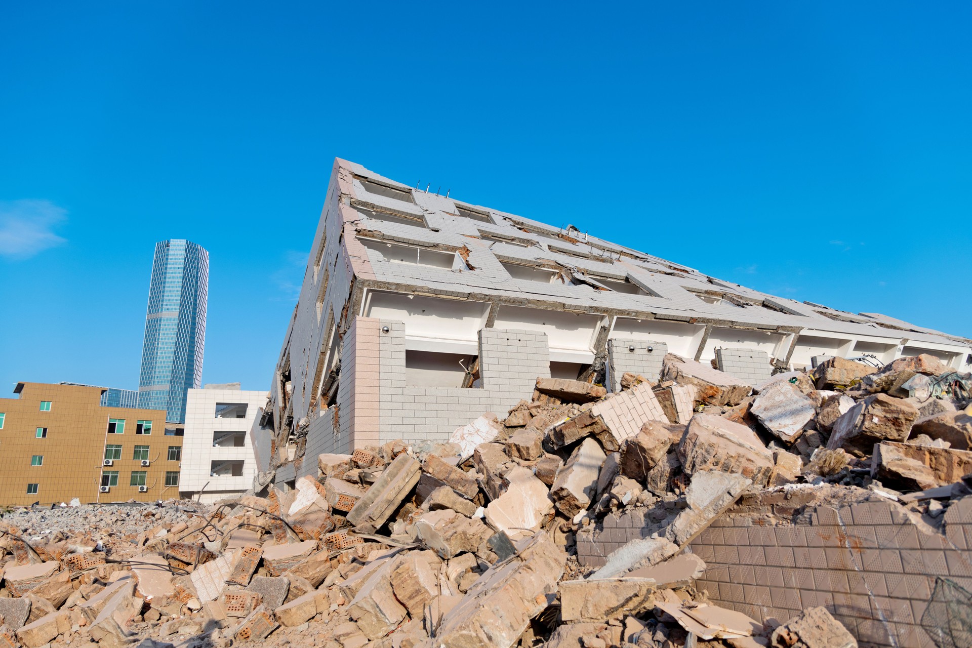 Contrast of demolished old house and modern office building